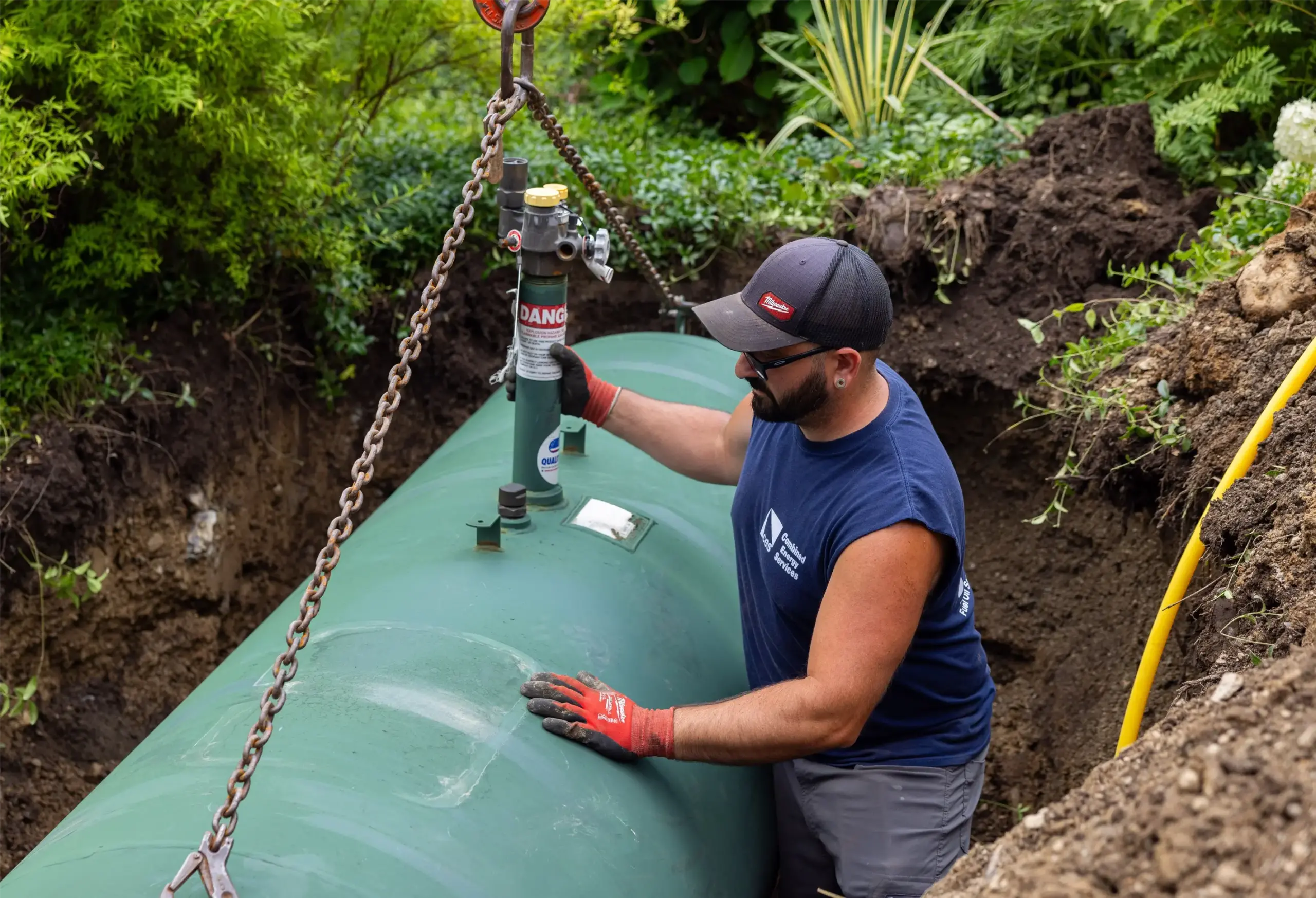 combined energy services worker installing tank