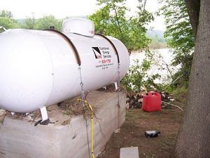 above ground tank with anchoring cables onto a solid foundation