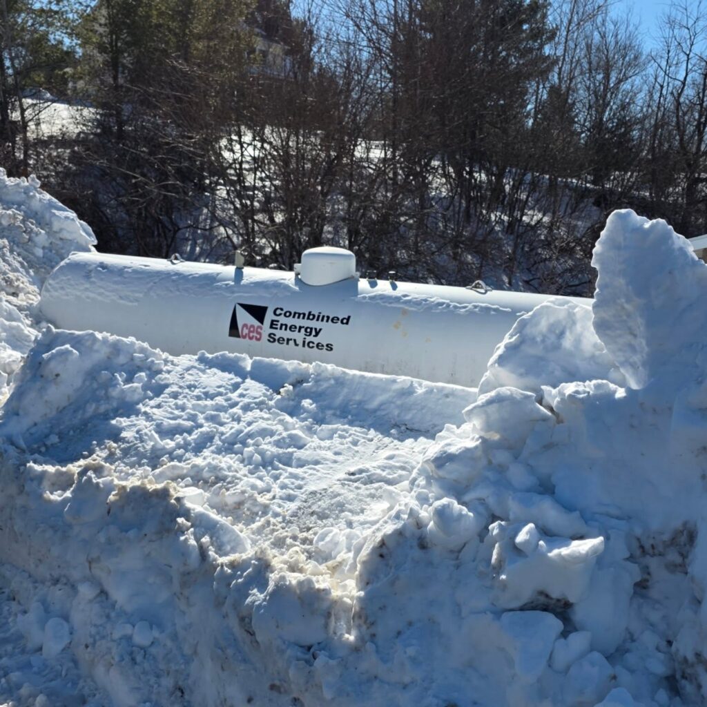 Propane tank buried in snow.
